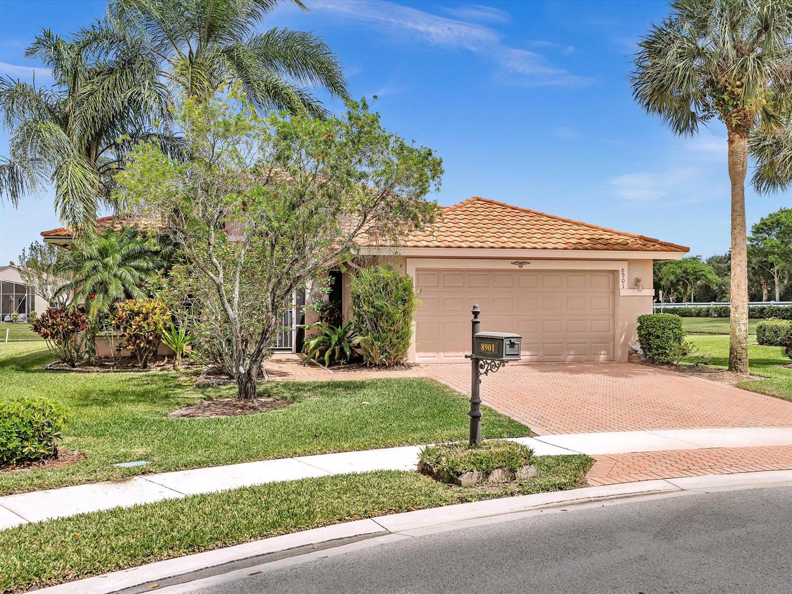 A single-story house with a tile roof, a brick driveway, and a mailbox in front — 8901 Agliana Circle, Boynton Beach FL 33472, BOYNTON BEACH, FL