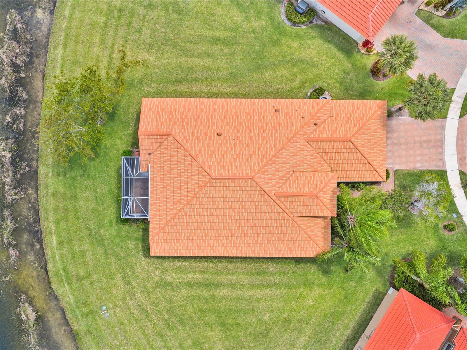 An aerial view shows a house with an orange tile roof and a screened-in patio — 8901 Agliana Circle, Boynton Beach FL 33472, BOYNTON BEACH, FL