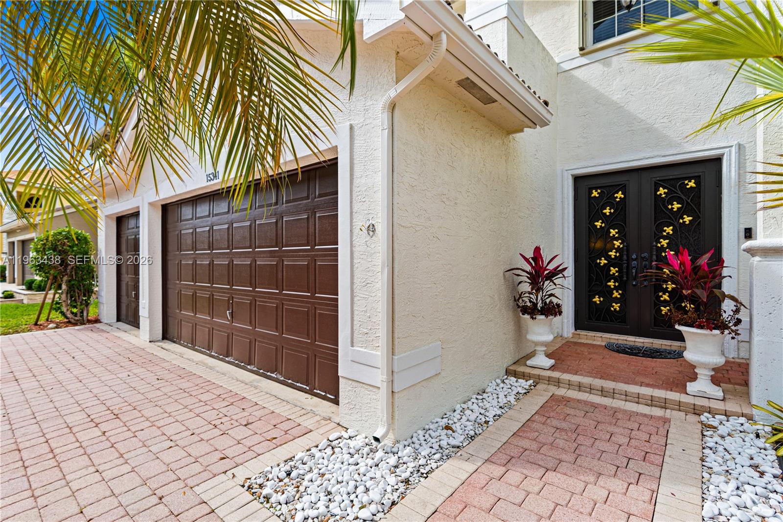 A house exterior features a brown garage door, a double front door, and brick pavers — 15341 SW 20th St, Miramar FL 33027, MIRAMAR, FL