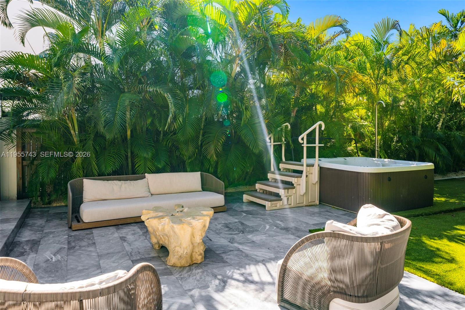 A patio features a hot tub, stairs, outdoor seating, and a wooden coffee table — 3166 Royal Palm Ave, Miami Beach FL 33140, MIAMI BEACH, FL