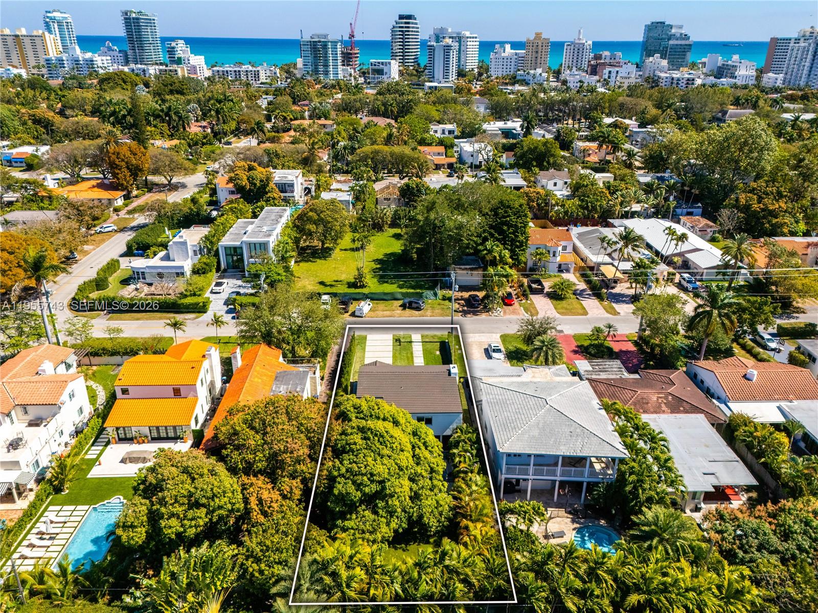 An aerial view shows a residential property with a large tree and swimming pool — 3166 Royal Palm Ave, Miami Beach FL 33140, MIAMI BEACH, FL
