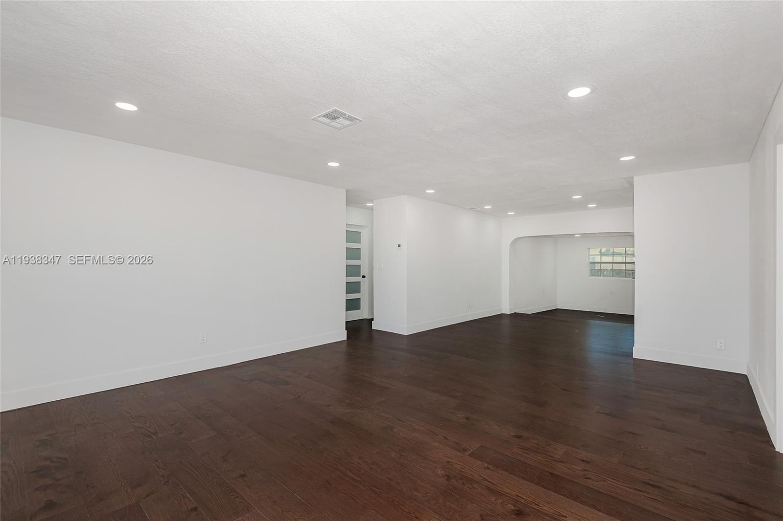 A spacious room features white walls, recessed lighting, and dark hardwood flooring — 4360 NW 4th St, Plantation FL 33317, PLANTATION, FL