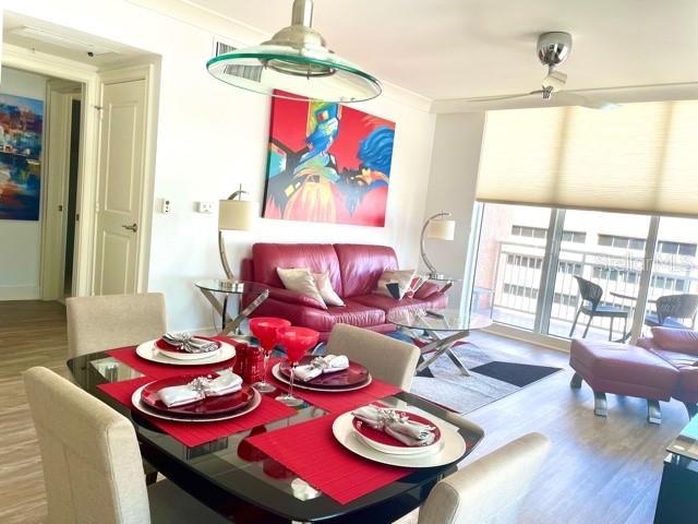 A dining area with a glass table and red placemats opens into a living room — 1350 MAIN STREET UNIT 909, SARASOTA, FL