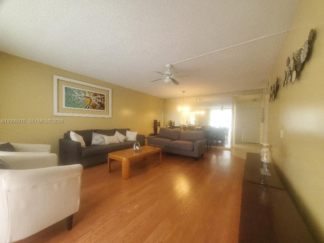 An outdoor swimming pool is surrounded by a paved deck and a multi-story apartment building — 319 NE 14th Ave # 207, Hallandale Beach FL 33009, HALLANDALE BEACH, FL