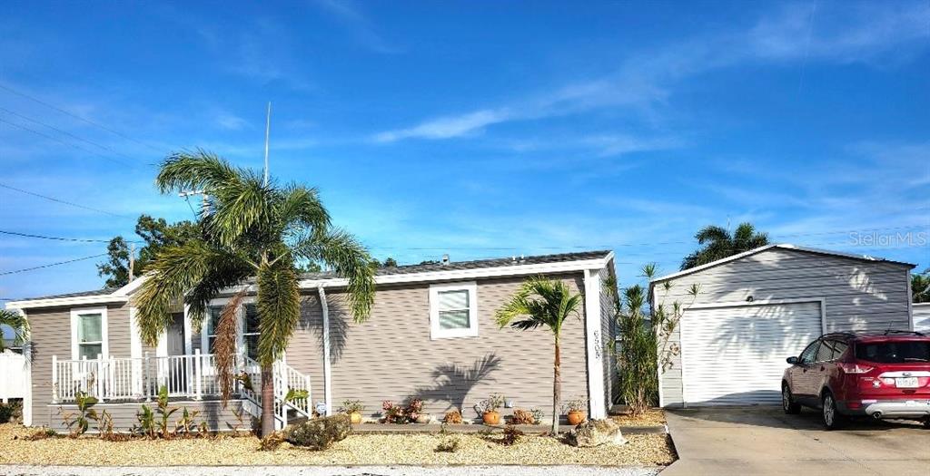 A single-story house with light gray siding, a front porch, and an attached garage — 6505 ARIZONA STREET, BRADENTON, FL