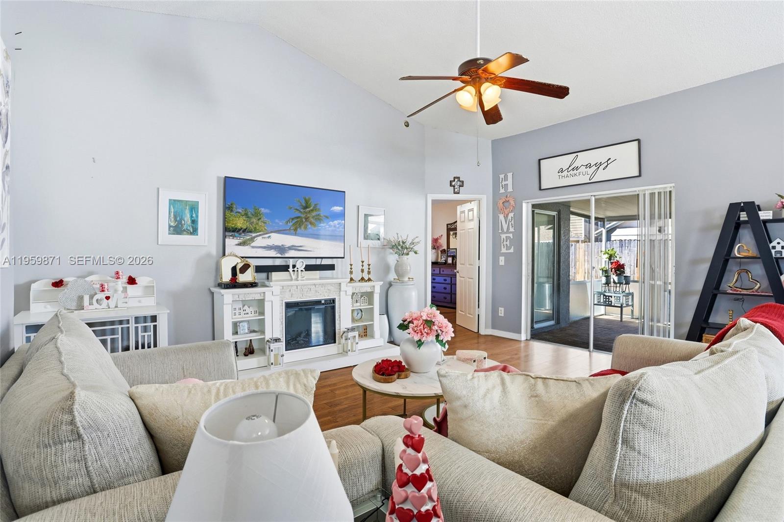 A living room features a fireplace, a ceiling fan, and a sliding glass door — 12608 Crayford ave, Orlando FL 32837, ORLANDO, FL