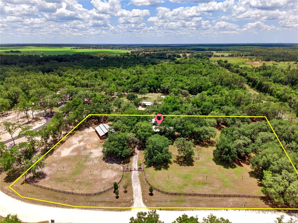 An aerial view shows a fenced rural property with a house, barn, and trees — 11630 SE 78TH STREET, MORRISTON, FL