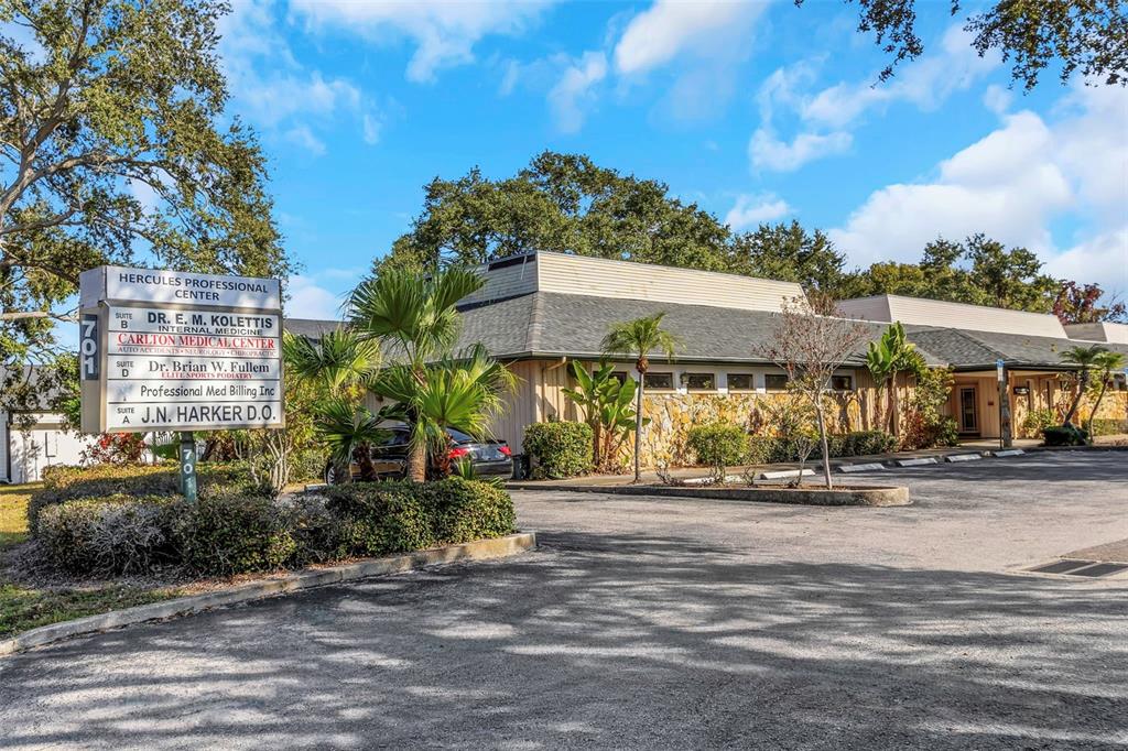 A low-rise professional medical center building with a stone facade and a parking lot — 701 N HERCULES AVENUE, CLEARWATER, FL