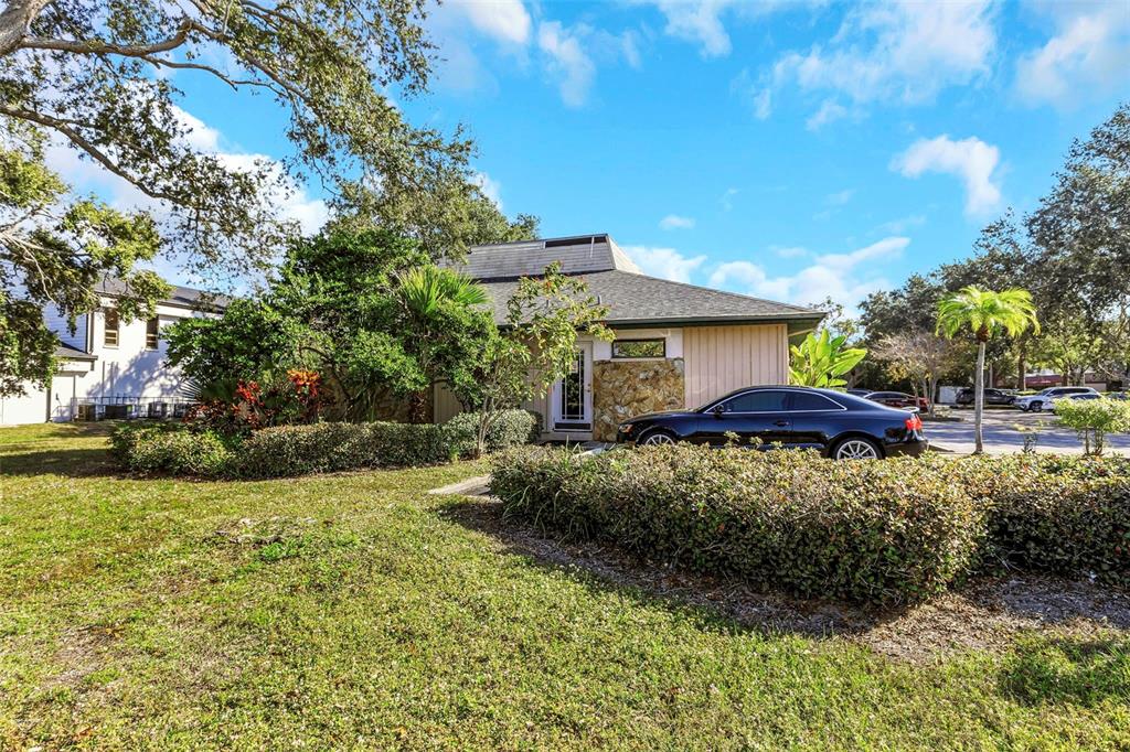 A single-story house with a stone facade and a black car parked in front — 701 N HERCULES AVENUE, CLEARWATER, FL
