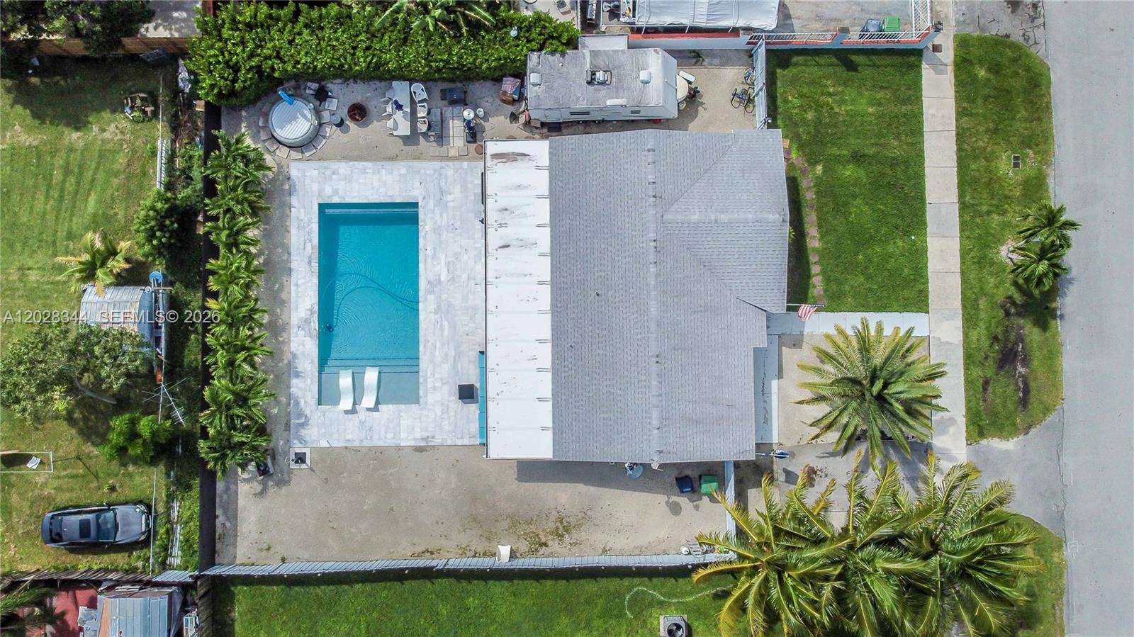 An aerial view shows a house with a pool, patio, and yard — 12100 SW 181st Ter, Miami FL 33177, MIAMI, FL