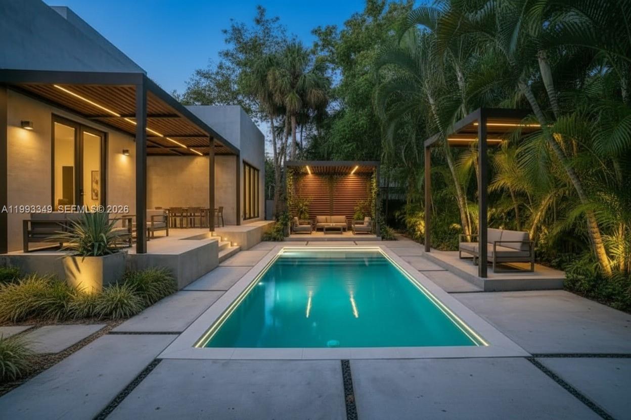 A modern backyard features a rectangular swimming pool, a covered patio, and two wooden pergolas — 680 NW 33rd St, Oakland Park FL 33309, OAKLAND PARK, FL