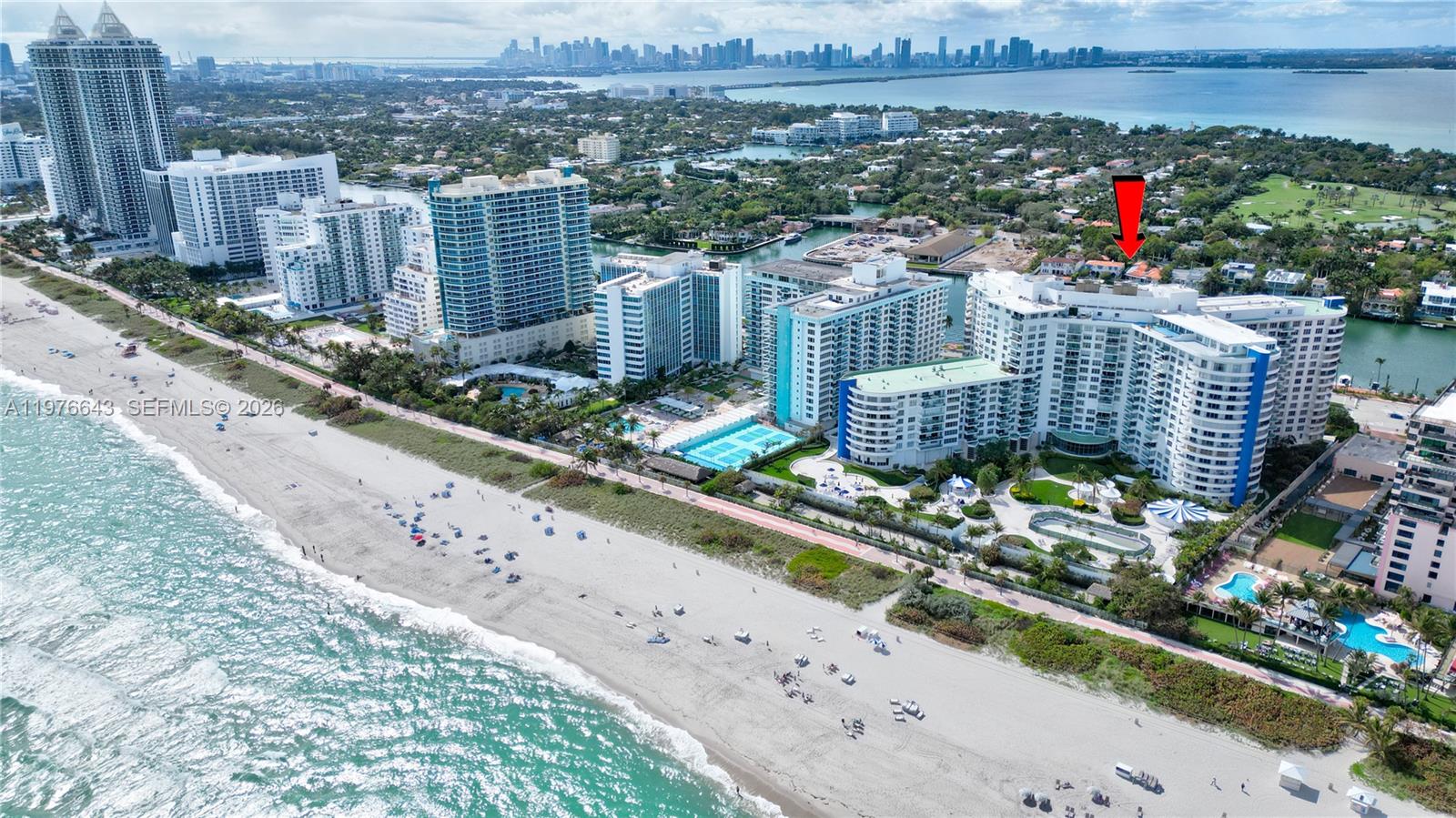 An aerial view shows a large beachfront condominium complex with a red arrow pointing inland — 5161 Collins Ave # 516, Miami Beach FL 33140, MIAMI BEACH, FL