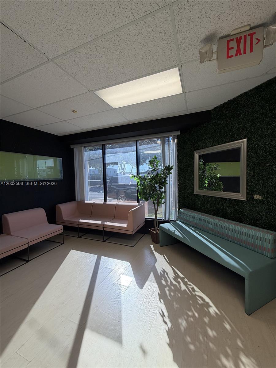 A waiting room features pink and teal benches, a faux-green wall, and large windows — 519 S 21st Ave, Hollywood FL 33020, HOLLYWOOD, FL