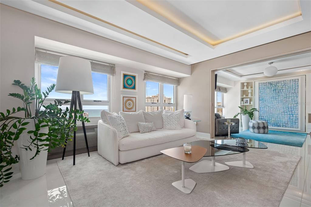 A bright living room features a white sofa, modern coffee tables, and a large floor lamp — Gallery Plaza DE DIEGO AVE. UNIT 1203-N, SAN JUAN, PR
