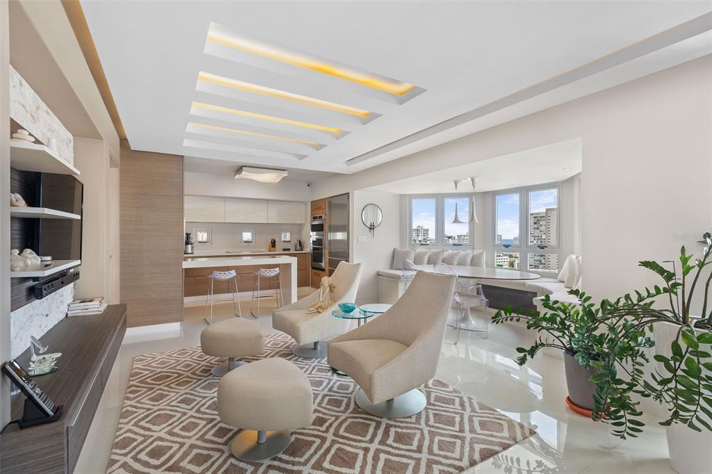 A modern open-concept living and dining area with a kitchen, marble accents, and city views — Gallery Plaza DE DIEGO AVE. UNIT 1203-N, SAN JUAN, PR