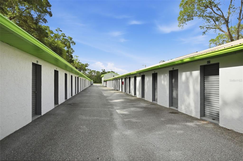 An outdoor view of a storage facility with rows of white units and green trim — 16331 CORTEZ BOULEVARD, BROOKSVILLE, FL