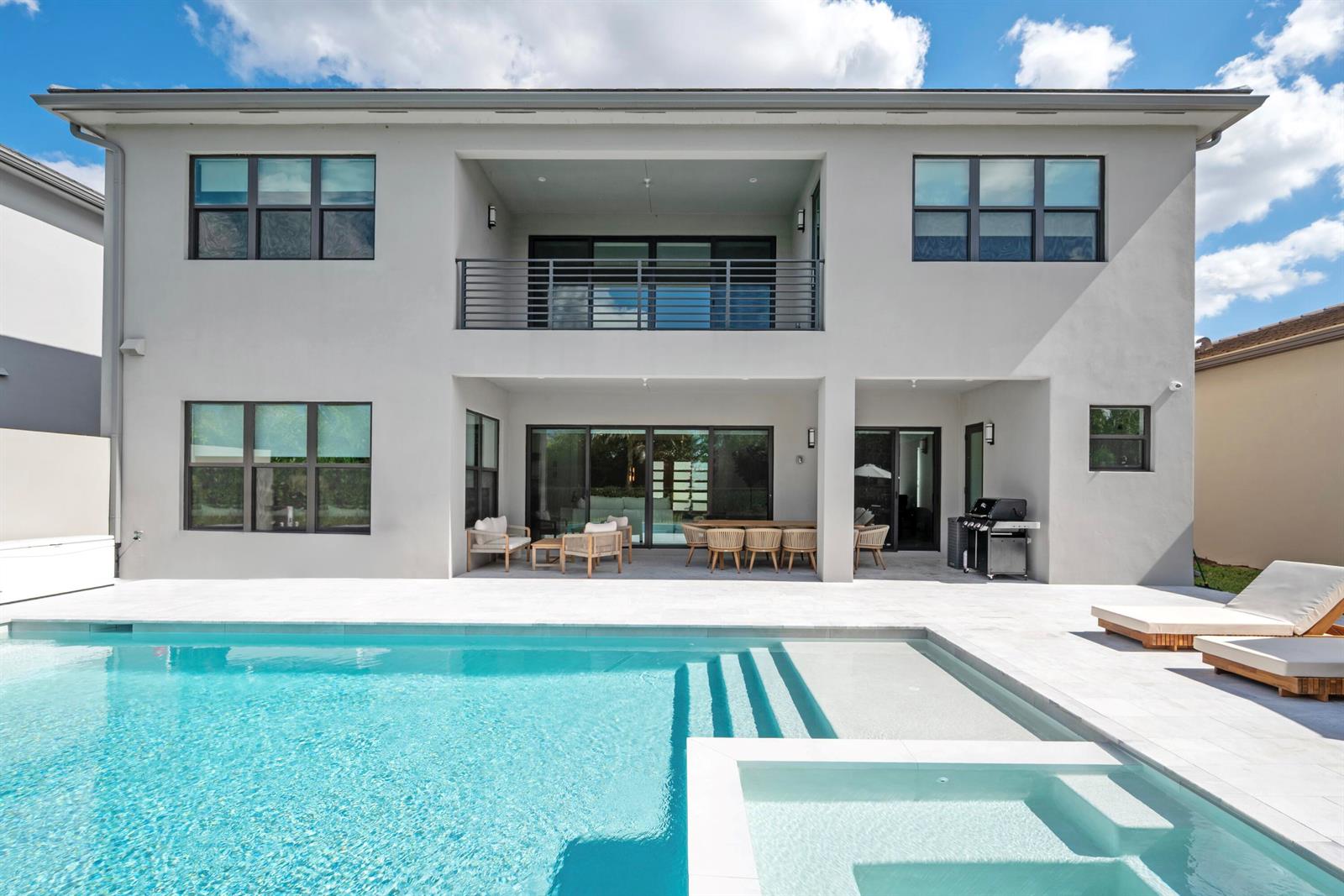 A two-story house exterior features a swimming pool, a covered patio, and a balcony — 20135 Casa De Campo Lane, Boca Raton FL 33434, BOCA RATON, FL