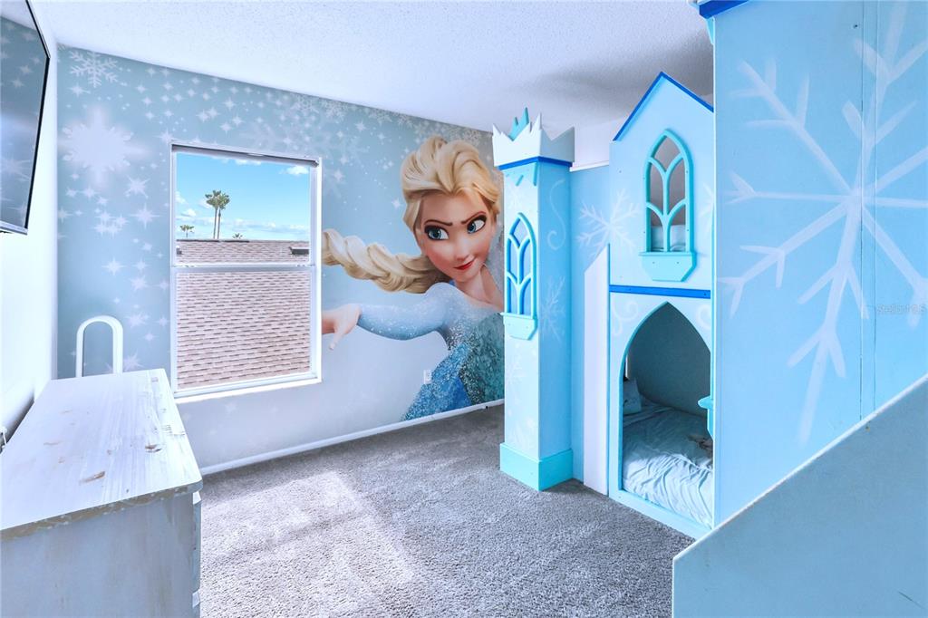 A bedroom features a large Elsa wall mural and a custom blue castle-themed bunk bed — 186 NAZHA DRIVE, DAVENPORT, FL