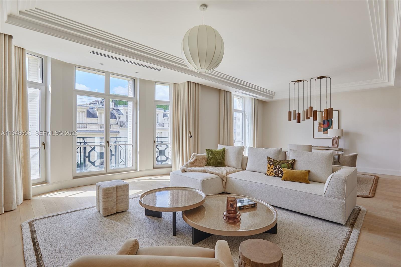 A bright living room features a white sectional sofa, two round coffee tables, and large windows — 9 Avenue Frederic Le Play # 401, Fr, Fr