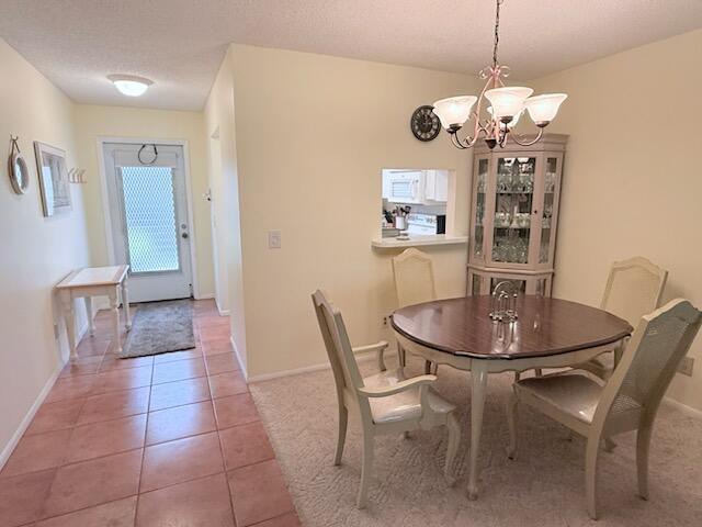 A dining area with a round table, chairs, and a hutch next to an entryway — 2950 SE Ocean Boulevard # 2, Stuart FL 34996, STUART, FL
