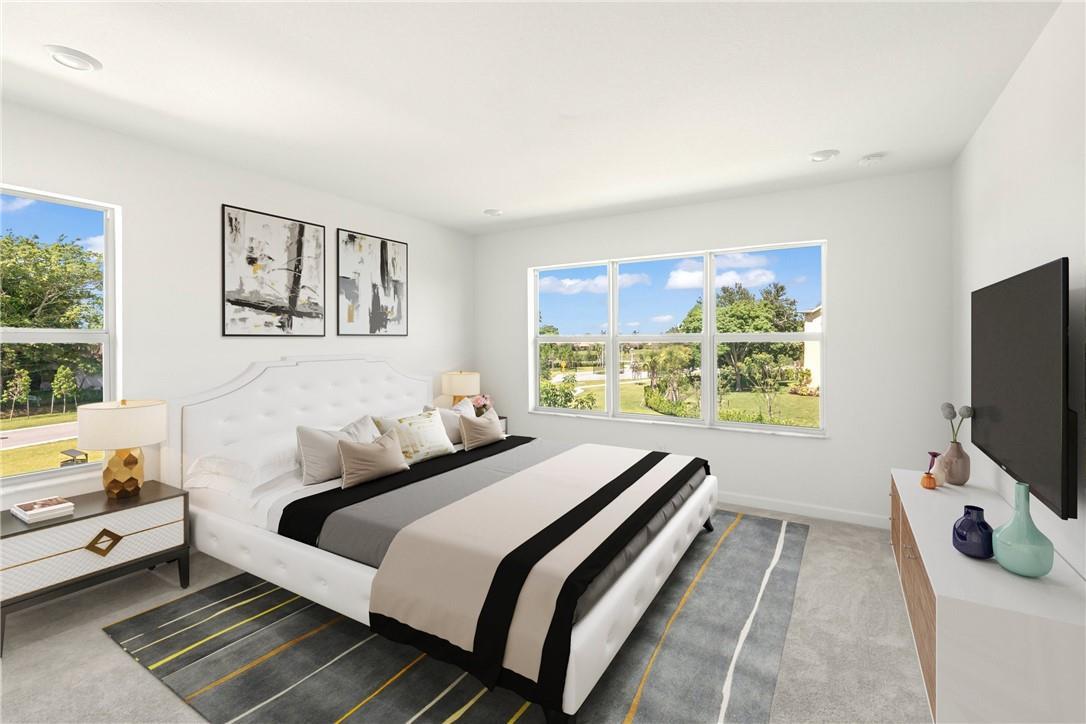 A bedroom features a white tufted bed, a patterned rug, and large windows with views — 5653 Stradella Drive, Boca Raton FL 33433, BOCA RATON, FL
