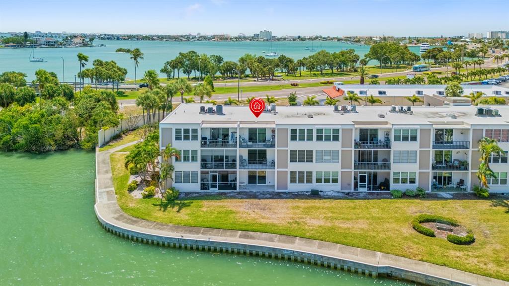 An aerial view of a multi-story waterfront condominium building with balconies overlooking a canal — 7401 BAY ISLAND DRIVE S UNIT 337, SOUTH PASADENA, FL