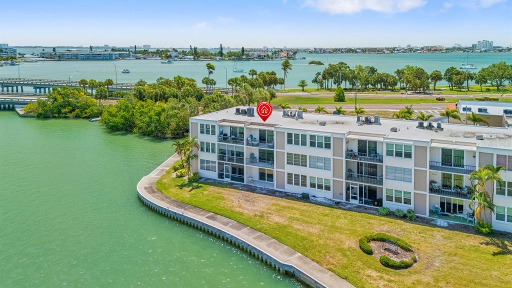 An aerial view of a multi-story waterfront apartment building with balconies overlooking a bay — 7401 BAY ISLAND DRIVE S UNIT 337, SOUTH PASADENA, FL