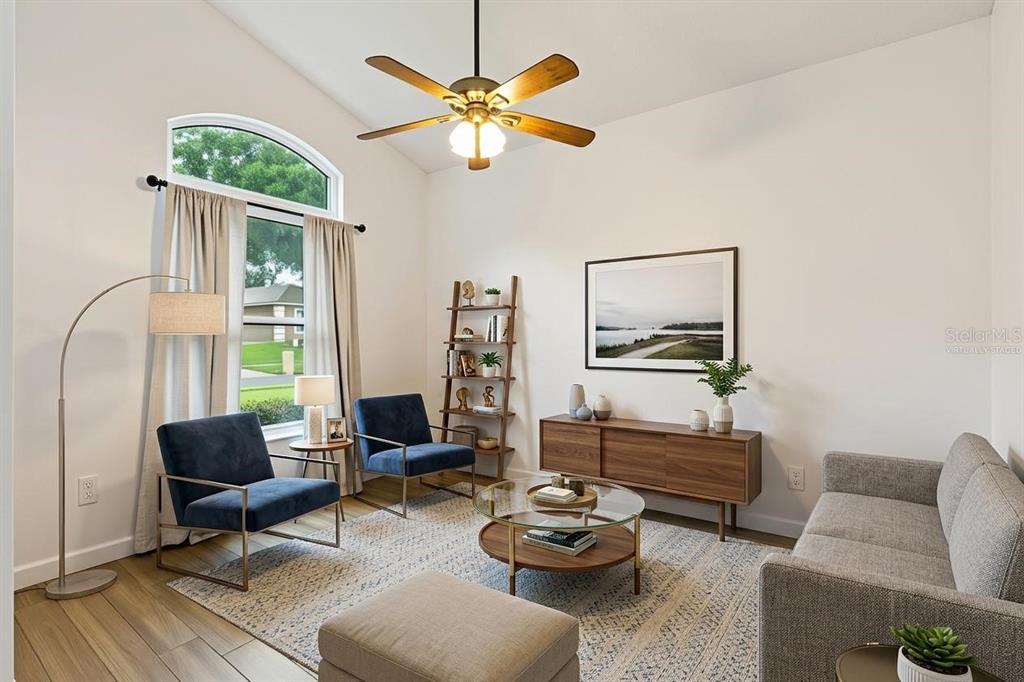 A living room features a vaulted ceiling, a ceiling fan, and a large arched window — 2331 RIDGESIDE ROAD, APOPKA, FL