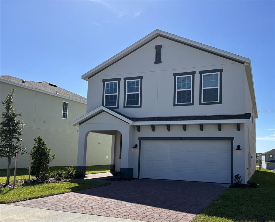A two-story house with a paved driveway, a two-car garage, and a covered entryway — 1879 CHURCH LAKE STREET, GROVELAND, FL