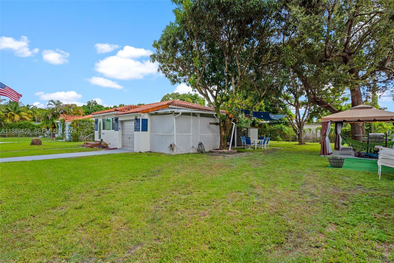 A single-story house with a white exterior, a tiled roof, and a large grassy yard — 5340 SW 5th St, Miami FL 33134, MIAMI, FL