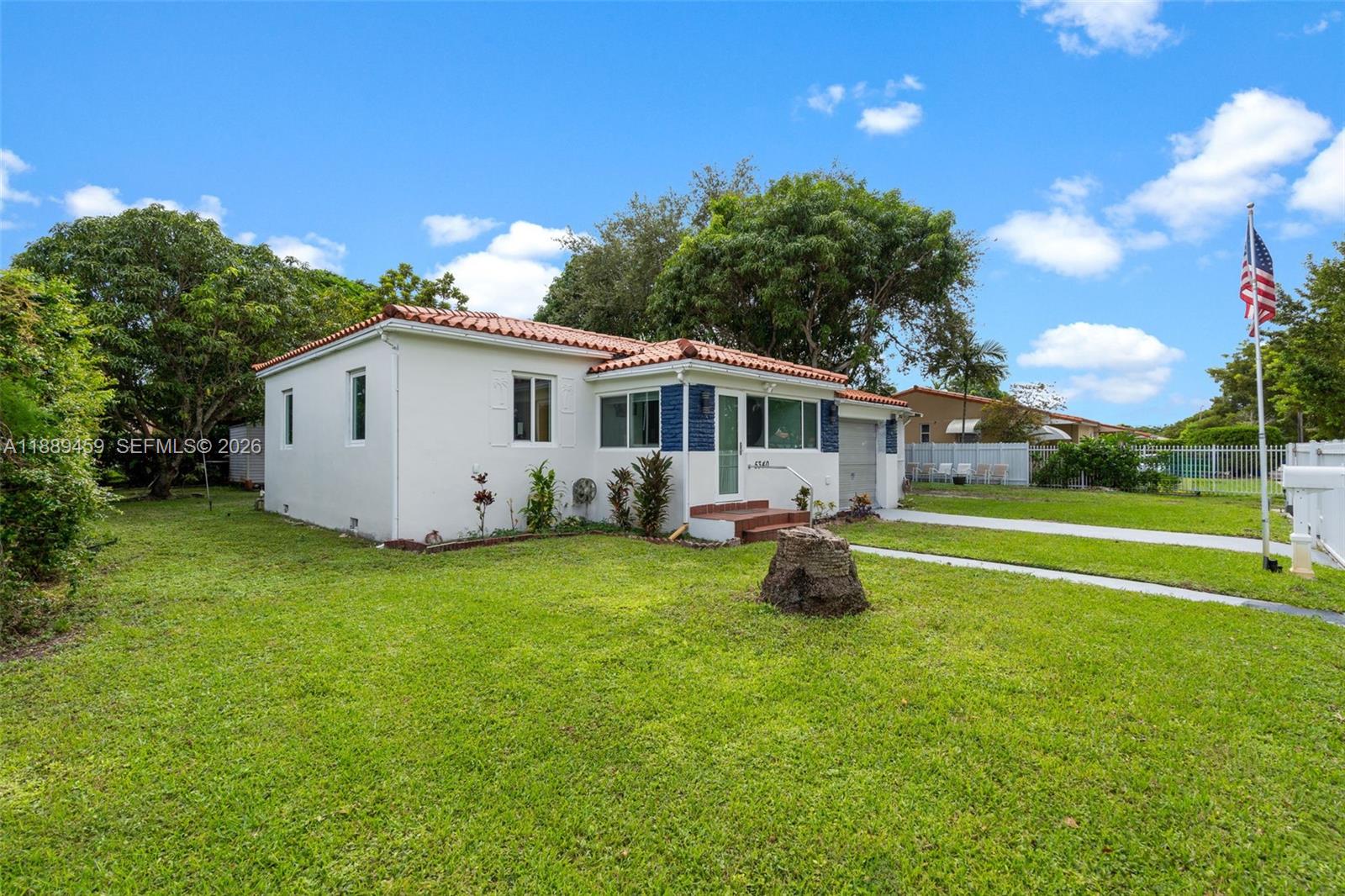 A white single-story house with a red tile roof and a front lawn — 5340 SW 5th St, Miami FL 33134, MIAMI, FL