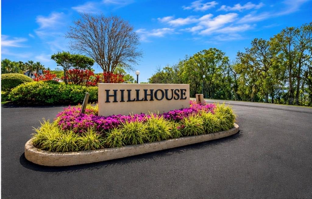 A beige sign reading Hillhouse sits in a landscaped island surrounded by asphalt roads — 601 W OLD US HIGHWAY 441 UNIT 3A, MOUNT DORA, FL