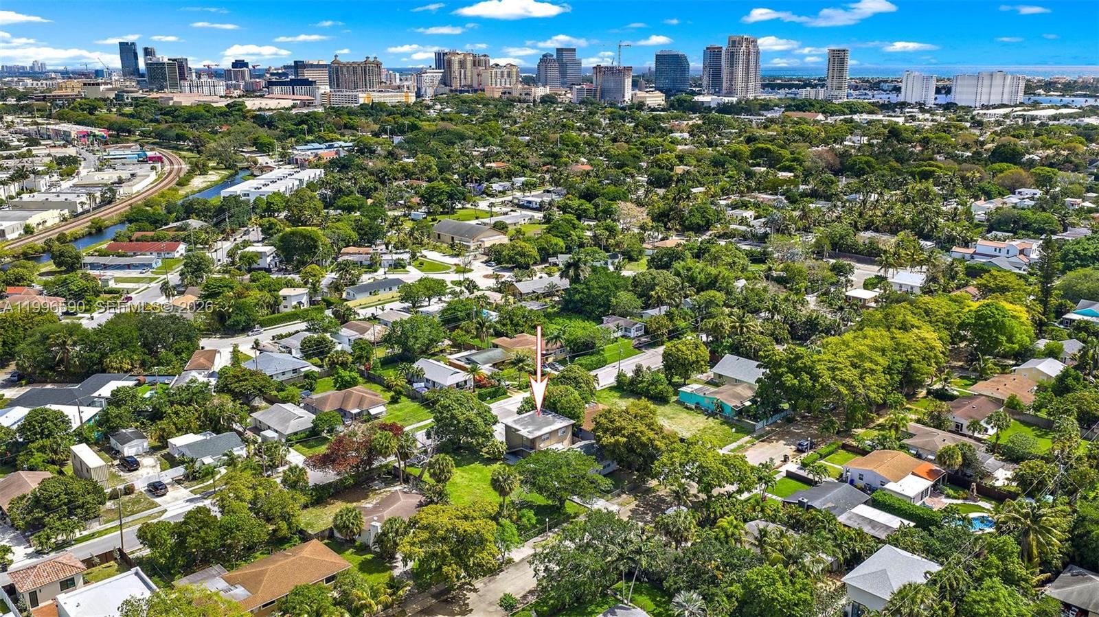 An aerial view shows a residential neighborhood with a red arrow pointing to a house — 940 Charles St, West Palm Beach FL 33401, WEST PALM BEACH, FL