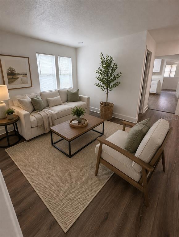 A living room features a beige sofa, a wooden coffee table, and a wooden armchair — 233 S RHODES STREET, MOUNT DORA, FL