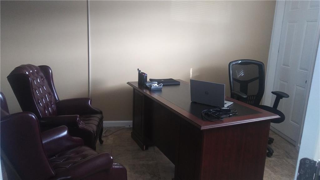 An office features a wooden desk, a mesh chair, and two burgundy leather armchairs — 27 SE 24 Avenue # 2, Pompano Beach FL 33062, POMPANO BEACH, FL