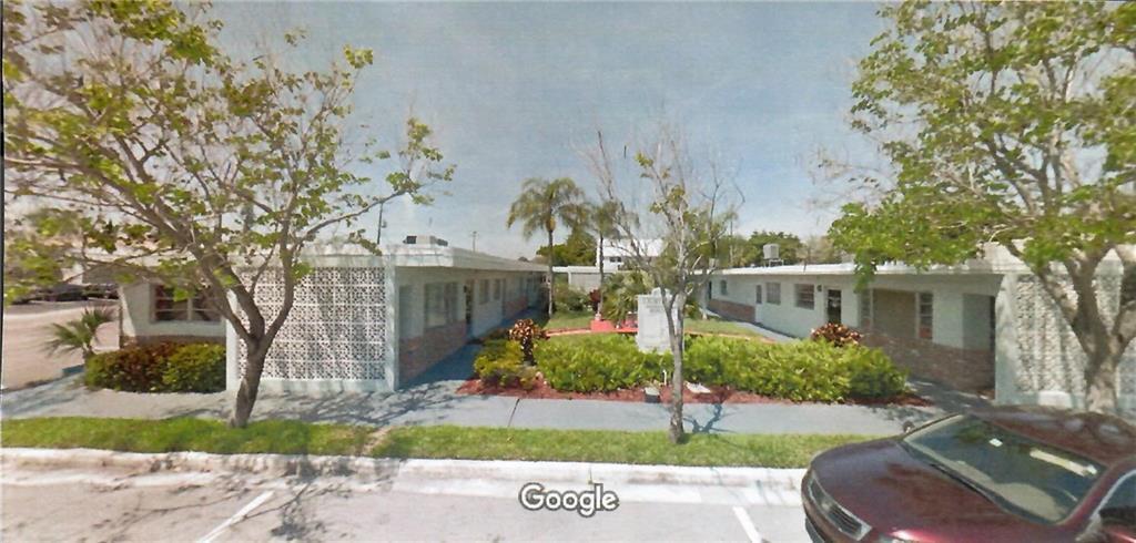 A low-rise apartment complex with decorative concrete block walls and a central landscaped courtyard — 27 SE 24 Avenue # 2, Pompano Beach FL 33062, POMPANO BEACH, FL