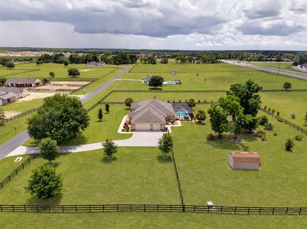 An aerial view shows a house with a pool, fenced pastures, and a small shed — 5178 SW 93RD LANE, OCALA, FL