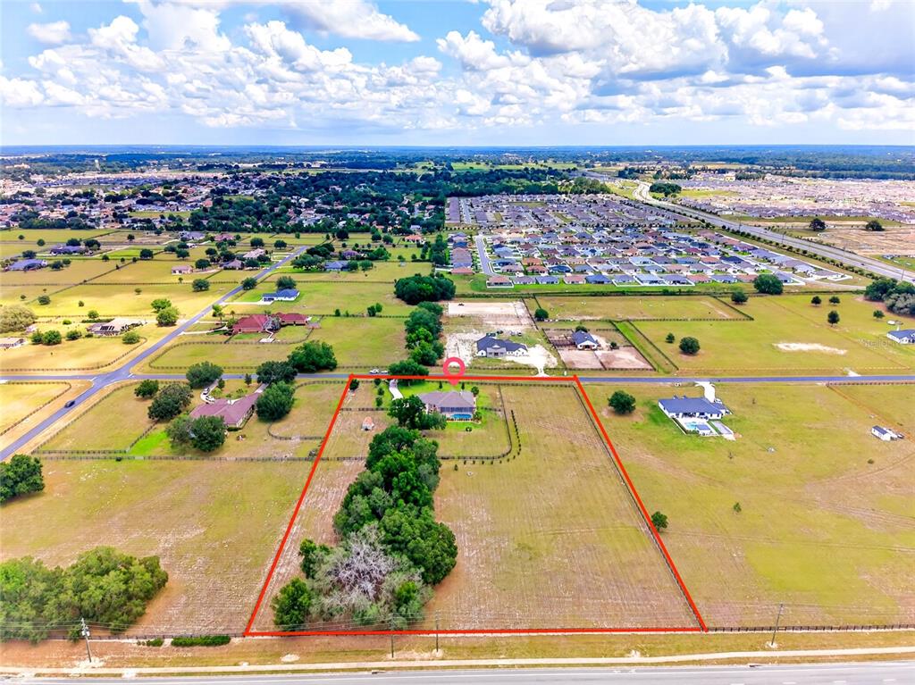 An aerial view shows a house with a pool on a large, fenced rural lot — 5178 SW 93RD LANE, OCALA, FL