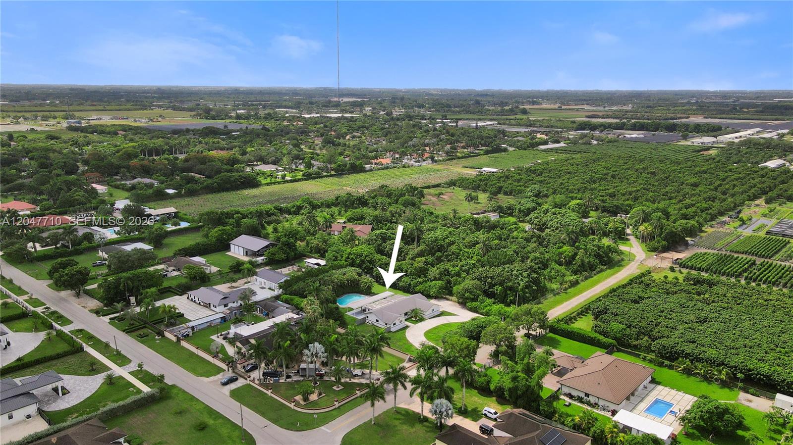 An aerial view shows a single-story house with a swimming pool surrounded by lush greenery — 22421 SW 184th Ave, Miami FL 33170, MIAMI, FL