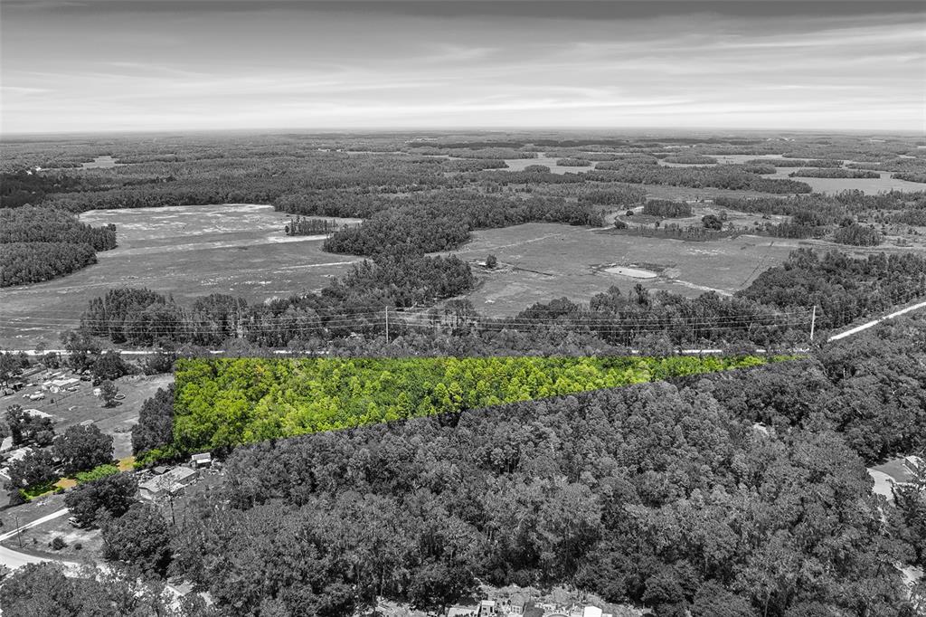 An aerial view shows a highlighted wooded lot bordered by a road and rural landscape — 0 COUNTRY HAVEN DRIVE, LAKELAND, FL