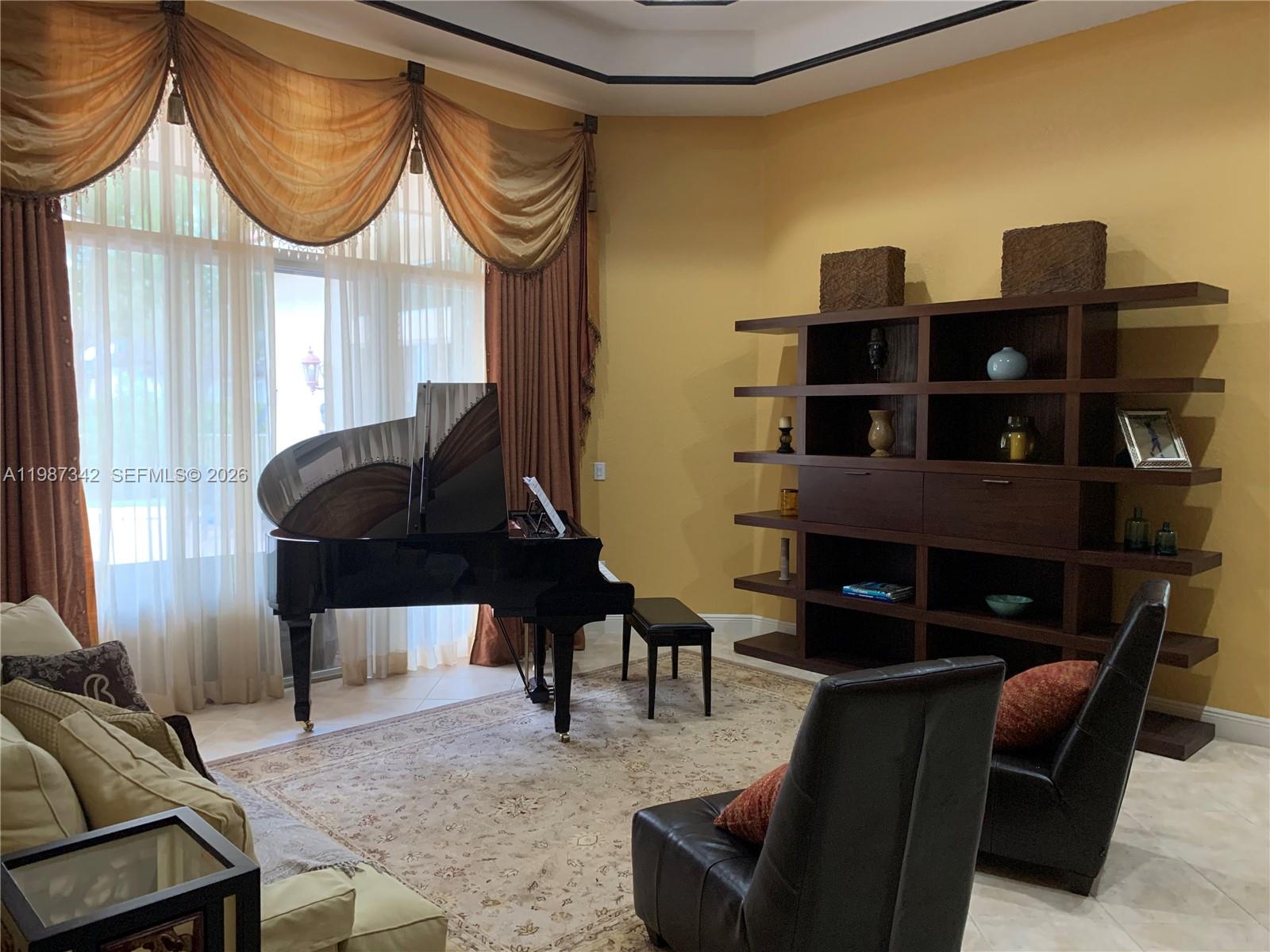 A living room features a grand piano, dark wood shelving, and gold-toned curtains — 4723 SW 195th Way, Miramar FL 33029, MIRAMAR, FL