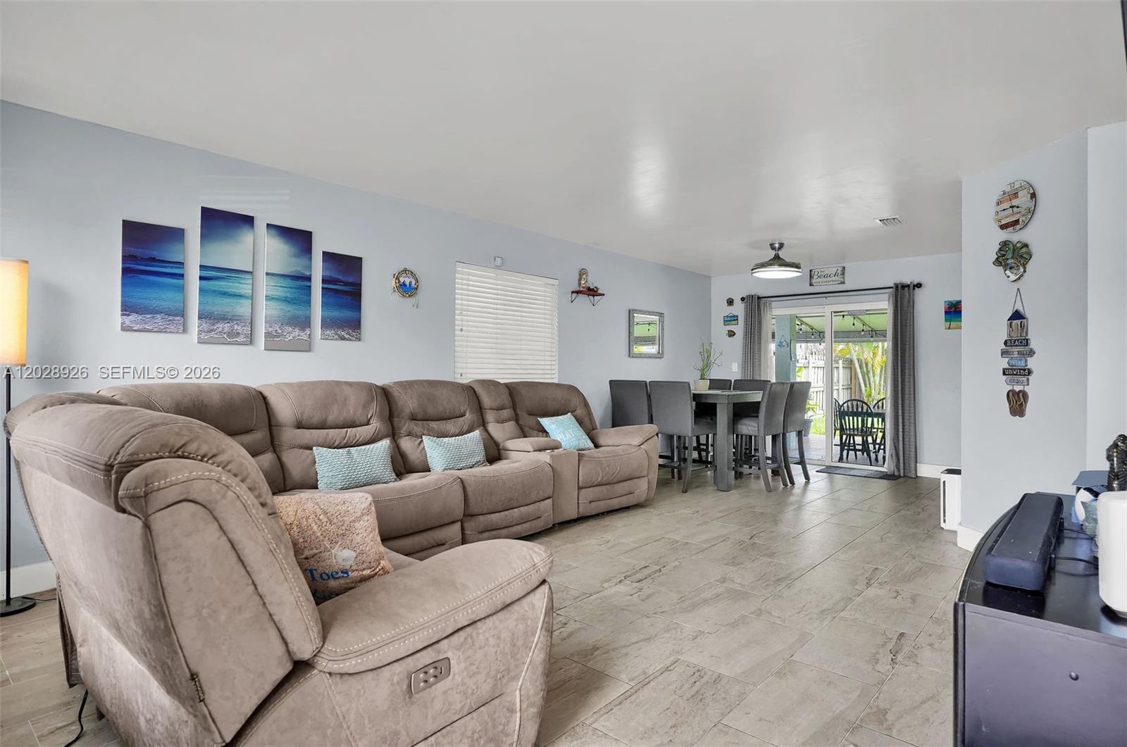 A living room features a large brown sectional sofa, dining area, and sliding glass doors — 14244 SW 163rd Ter, Miami FL 33177, MIAMI, FL