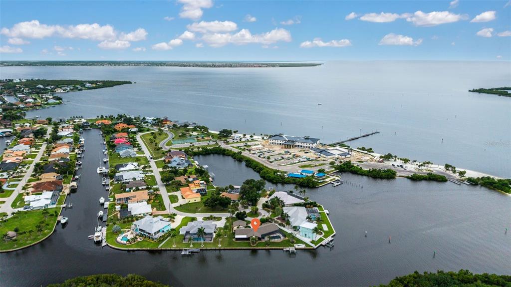 An aerial view shows a waterfront residential neighborhood with a marked house on a peninsula — 4589 COLLEEN STREET, PORT CHARLOTTE, FL