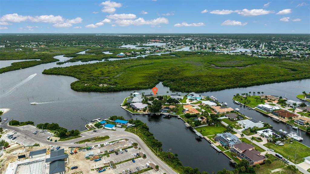 An aerial view shows a waterfront residential area with a marked house and surrounding mangroves — 4589 COLLEEN STREET, PORT CHARLOTTE, FL