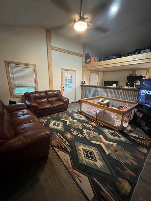 A living room features leather sofas, a patterned rug, a playpen, and a loft area — 3830 COUNTY ROAD 547 N, DAVENPORT, FL