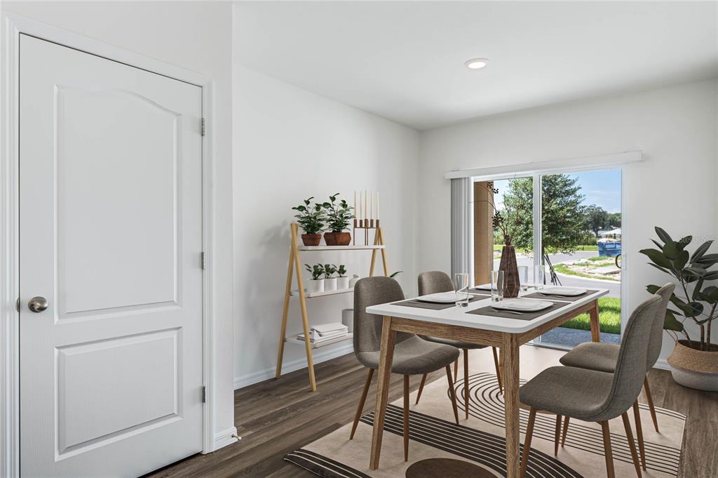 A dining area features a white table, four gray chairs, a tiered shelf, and sliding doors — 5130 CLUSIA DRIVE, APOPKA, FL