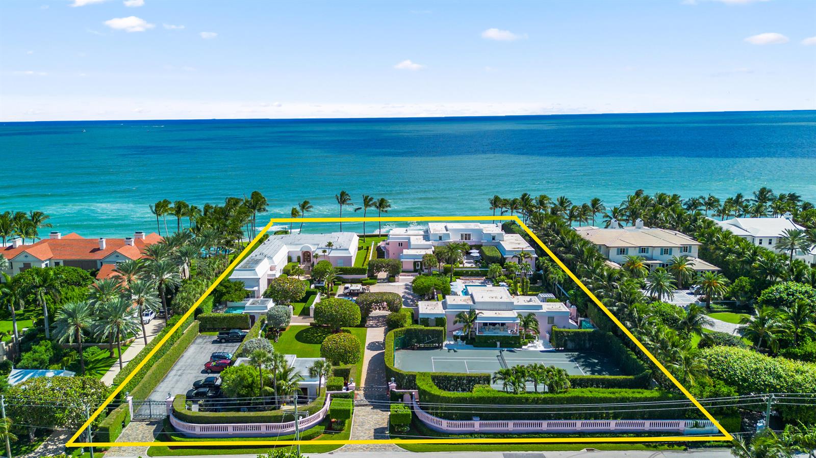 An aerial view shows a large beachfront estate with a tennis court and swimming pool — 911 N Ocean Boulevard, Palm Beach FL 33480, PALM BEACH, FL