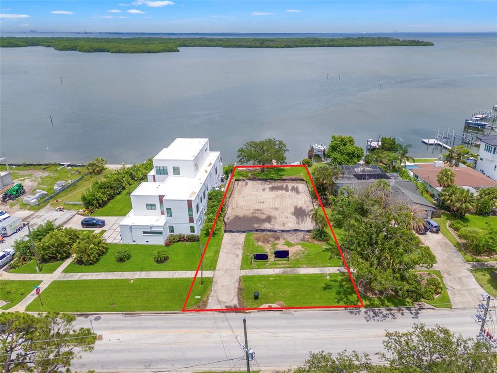 A sunset view over a body of water with distant shorelines on both sides — 6151 BAYOU GRANDE BOULEVARD NE, ST PETERSBURG, FL