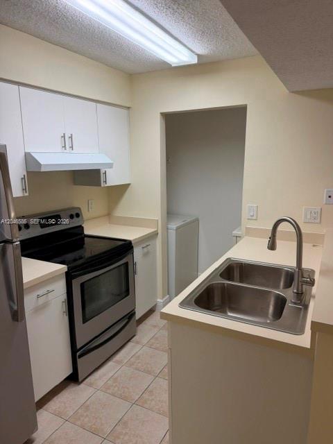 A kitchen with white cabinets, stainless steel appliances, a double sink, and tiled flooring — 1249 SW 46th Ave # 1401, Pompano Beach FL 33069, POMPANO BEACH, FL