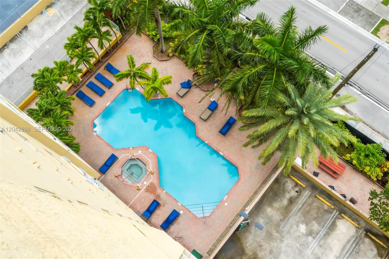 An aerial view shows a swimming pool and hot tub surrounded by lounge chairs — 3500 Coral Way # 707, Miami FL 33145, MIAMI, FL